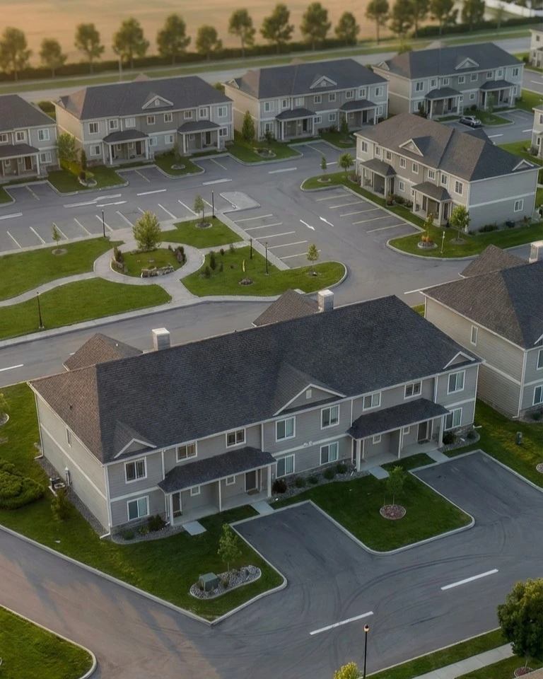 Aerial view of townhouse community planning with parking courts, access roads, and landscaped open space
